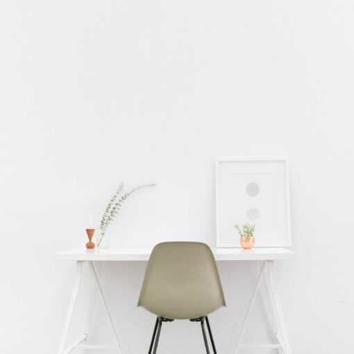 beige and black chair in front of white desk